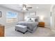 This main bedroom features a gray upholstered bed and bench, light gray walls, and large window to let in the light at 12759 Buffington Trl, Parker, CO 80134