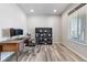 Home office with wood desk, black office chair, black bookcase, and natural light coming from window at 12759 Buffington Trl, Parker, CO 80134