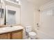 Bathroom features a vanity, mirror, toilet, and a shower over tub at 5522 S Quemoy Cir, Aurora, CO 80015