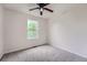 Bedroom features neutral carpet, ceiling fan and a window at 5522 S Quemoy Cir, Aurora, CO 80015