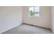 Bedroom features neutral carpet, a window and white walls at 5522 S Quemoy Cir, Aurora, CO 80015