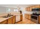 Kitchen features stainless steel appliances, wood cabinets, and hardwood floors at 5522 S Quemoy Cir, Aurora, CO 80015