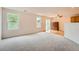 Spacious living room with large windows, ceiling fan, and sliding doors to outdoor space at 5522 S Quemoy Cir, Aurora, CO 80015