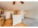 Open-concept living area with hardwood floors in kitchen and carpet in living area at 5522 S Quemoy Cir, Aurora, CO 80015