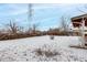 Snowy backyard with a fenced perimeter and a covered patio at 5332 Granby St, Denver, CO 80239