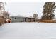 Backyard view of home with covered patio and dog house at 5332 Granby St, Denver, CO 80239