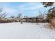 Backyard view of home with covered patio and dog house at 5332 Granby St, Denver, CO 80239