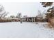 Backyard view of home with covered patio and dog house at 5332 Granby St, Denver, CO 80239