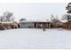 Backyard view of home with covered patio and dog house at 5332 Granby St, Denver, CO 80239