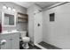 Clean bathroom with a wave-patterned shower and pebble floor at 5332 Granby St, Denver, CO 80239