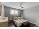 Bright bedroom with a queen bed, wooden dresser, and ceiling fan at 5332 Granby St, Denver, CO 80239