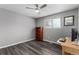 Home office in a bedroom with wood-look floors and built-in shelves at 5332 Granby St, Denver, CO 80239