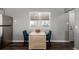 Small dining area with a drop leaf table and two blue chairs at 5332 Granby St, Denver, CO 80239