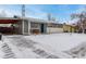 Ranch style home with gray siding, snowy front yard, and a covered carport at 5332 Granby St, Denver, CO 80239