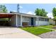 Charming single-story home with a blue front door, well-maintained lawn, and a covered parking area at 5332 Granby St, Denver, CO 80239