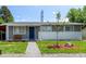 Well-maintained gray home with a blue door, green lawn, and decorative landscaping at 5332 Granby St, Denver, CO 80239