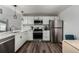 Modern kitchen with white cabinets, stainless steel appliances, and quartz countertops at 5332 Granby St, Denver, CO 80239