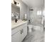 Updated bathroom featuring modern tiling, a bathtub, and a white vanity with matte black fixtures at 2890 S Sherman St, Englewood, CO 80113