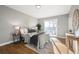 Bright bedroom featuring hardwood floors, a sliding glass door to a balcony, and light gray walls at 2890 S Sherman St, Englewood, CO 80113