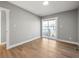 Empty bedroom featuring hardwood floors and a sliding glass door to a balcony at 2890 S Sherman St, Englewood, CO 80113