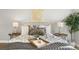 Close up on the bed featuring stylish decor, lamps, and an interesting arrangement of pillows at 2890 S Sherman St, Englewood, CO 80113