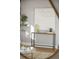 Hall table vignette features artistic decor accents against a neutral wall color at 2890 S Sherman St, Englewood, CO 80113