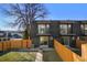 Townhome exterior with backyard including grass, garden and wooden fence at 2890 S Sherman St, Englewood, CO 80113