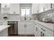 Close-up of the updated kitchen, boasting white cabinets and modern stainless steel appliances at 2890 S Sherman St, Englewood, CO 80113