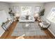 Bright living room featuring hardwood floors, sofa, area rug, and natural light at 2890 S Sherman St, Englewood, CO 80113