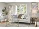 Sunlit living room featuring a large window, comfortable seating, and stylish decor at 2890 S Sherman St, Englewood, CO 80113