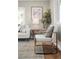 Bright living room featuring a cozy chair, modern decor, and natural light streaming through large windows at 2890 S Sherman St, Englewood, CO 80113