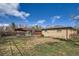 Spacious backyard featuring a charming playhouse and ample room for outdoor activities and relaxation at 6033 Hoyt Ct, Arvada, CO 80004
