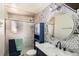 Stylish bathroom featuring a sleek vanity, decorative tiles, and a glass-enclosed shower at 6033 Hoyt Ct, Arvada, CO 80004