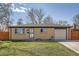 Charming single-story brick home with a well-manicured lawn and an attached one car garage at 6033 Hoyt Ct, Arvada, CO 80004