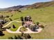 Aerial view of an estate on a large, manicured lot with mountain views in the background at 27 Tamarade Dr, Littleton, CO 80127