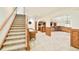 Finished basement area with carpeted stairs, a game area, and a wet bar setup at 27 Tamarade Dr, Littleton, CO 80127