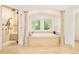 Luxurious bathroom features a soaking tub with a view, and a glass enclosed shower at 27 Tamarade Dr, Littleton, CO 80127