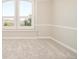 Bedroom featuring large windows with scenic views and neutral carpet and paint at 27 Tamarade Dr, Littleton, CO 80127