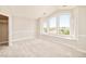 Bright bedroom featuring large windows with scenic views and neutral carpet and paint at 27 Tamarade Dr, Littleton, CO 80127