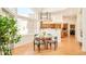Bright dining area features hardwood floors, modern chandelier, and large windows offering ample natural light at 27 Tamarade Dr, Littleton, CO 80127
