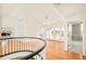 Bright foyer boasts wood floors, built-in shelving, and double doors to a balcony with scenic views at 27 Tamarade Dr, Littleton, CO 80127