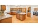 Spacious kitchen featuring stainless steel appliances, granite countertops, and custom cabinetry for ample storage at 27 Tamarade Dr, Littleton, CO 80127