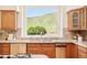 Gourmet kitchen featuring stainless appliances, custom cabinetry, and a picturesque window overlooking the mountains at 27 Tamarade Dr, Littleton, CO 80127