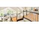 Elegant curved staircase overlooks a living area with lots of natural light and a fireplace with mountain views at 27 Tamarade Dr, Littleton, CO 80127