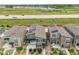 Eye-level aerial view of townhomes equipped with solar panels near a calm body of water at 847 Great Plains Ave, Berthoud, CO 80513