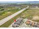 Aerial view points to the location of townhomes in a neighborhood near highway and lakes at 847 Great Plains Ave, Berthoud, CO 80513