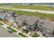 Aerial view of townhomes equipped with solar panels, lush landscaping, and proximity to a lake at 847 Great Plains Ave, Berthoud, CO 80513