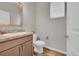 Bright bathroom featuring wood-look vinyl flooring, a toilet, and a vanity with a light-colored countertop at 847 Great Plains Ave, Berthoud, CO 80513