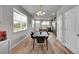 Contemporary dining area leads to kitchen and living space, perfect for gatherings and everyday living at 847 Great Plains Ave, Berthoud, CO 80513