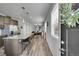 Open-concept kitchen featuring a large island, pendant lighting, and stainless steel appliances, perfect for modern living at 847 Great Plains Ave, Berthoud, CO 80513